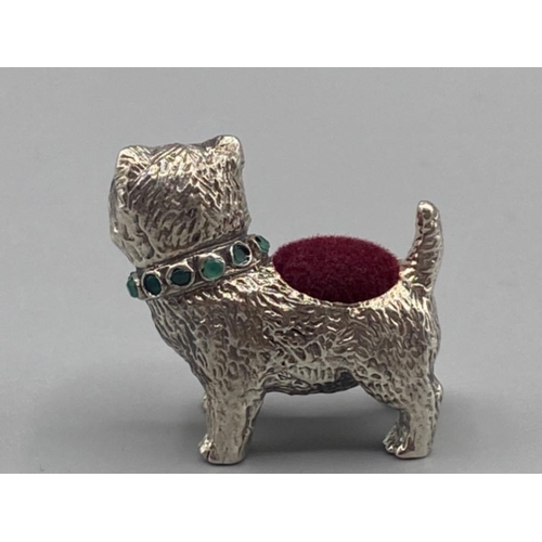 73 - A silver scotty dog pincushion with ruby eyes and emerald collar, 17.4g