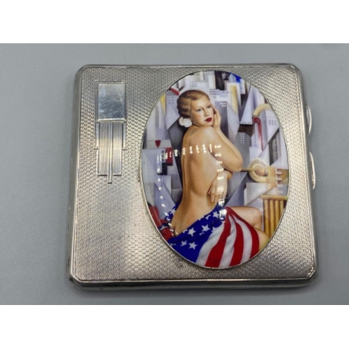 75 - A silver case with enamel plaque depicting a semi naked female