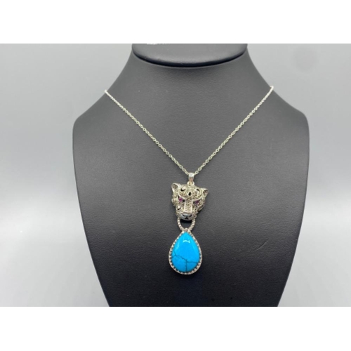 88 - A substantial silver leopards head pendant necklace with turquoise drop, 12.9g