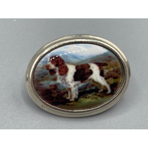 93 - A pair of silver and enamel set of cufflinks depicting a dog, 9.0g