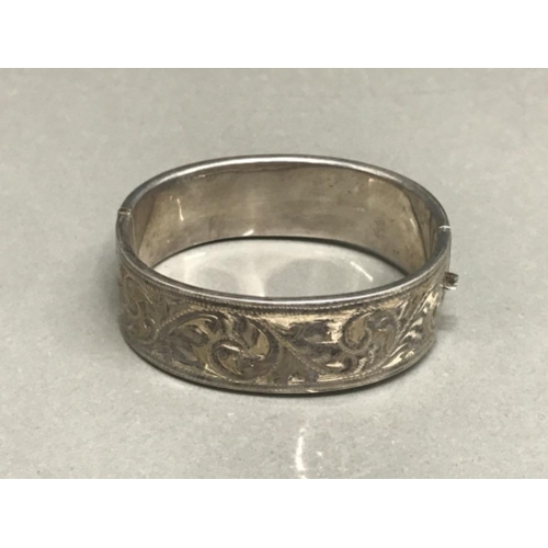 124 - Silver half engraved hinged bangle 23.68g