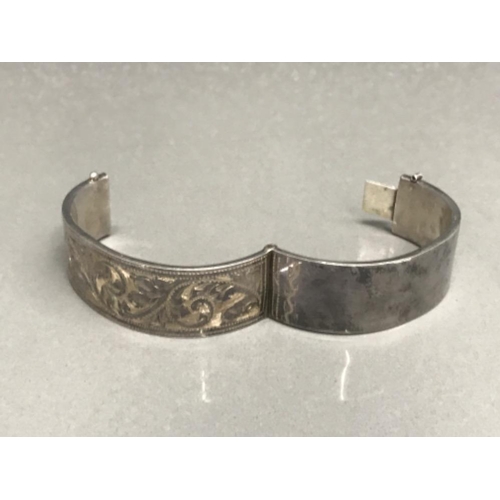 124 - Silver half engraved hinged bangle 23.68g