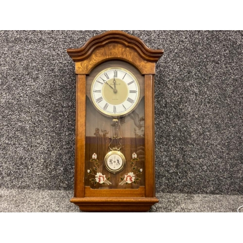 253 - London Clock Co chiming wall clock in flame & standard mahogany case, working condition (though chim... 