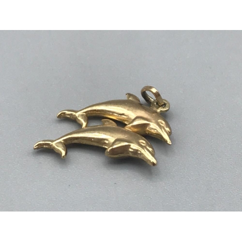 86 - 9ct gold jumping dolphins charm 0.7g