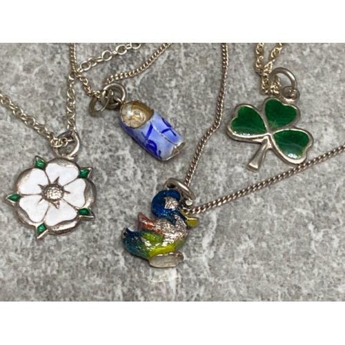 296 - 4x silver chains with various silver pendants including Yorkshire rose, enamelled duck, boot & shamr... 