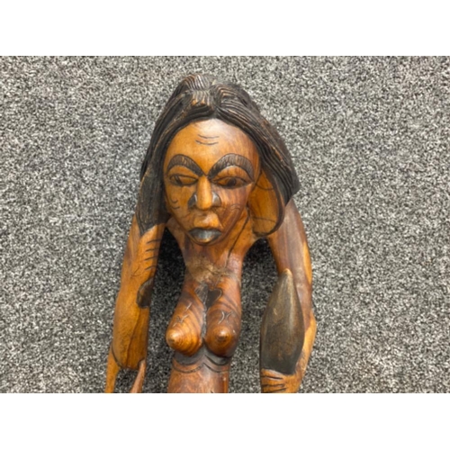 35 - Tall 22” hand carved sitting nude lady with leopard skin bag on her arm