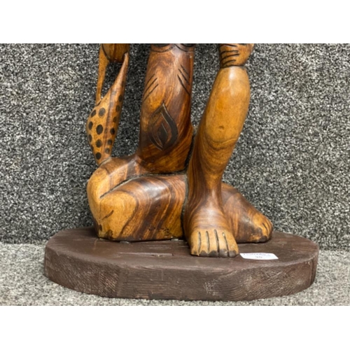 35 - Tall 22” hand carved sitting nude lady with leopard skin bag on her arm