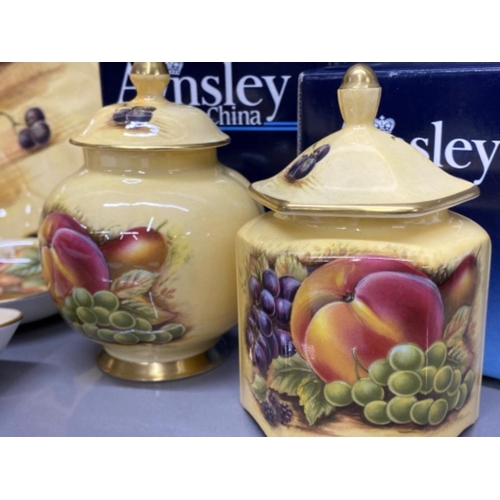 148 - 7 pieces of Aynsley “Orchard Gold patterned” collectible items, includes plates, lidded pots & vase