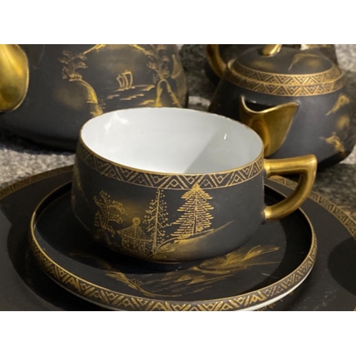 220 - A collection of mount Fiji tea set in black and gold