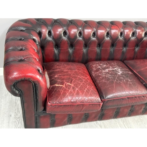 369 - Ox-blood leather metal studded 3 seater chesterfield sofa