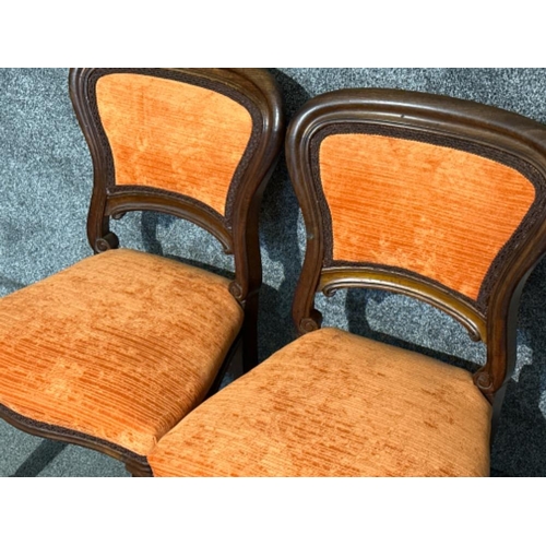 94 - Pair of Victorian chairs, upholstered in an orange fabric with a matching footstool