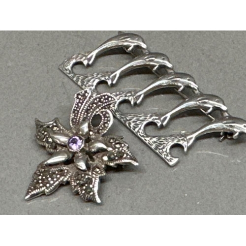 27 - Silver Dolphin brooch and silver, Marcasite & amethyst ‘Flower’ brooch - 12.9G gross