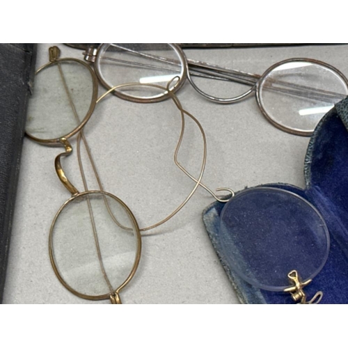 75 - Vintage tin containing 6 pairs of vintage spectacles also includes The St. John Ambulance Associatio... 