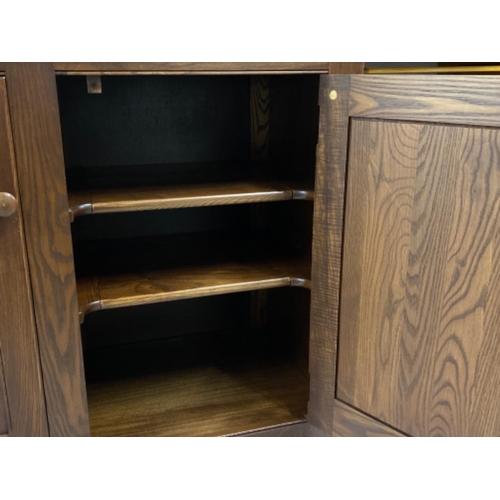 321 - Dark Ercol double door cupboard, with twist handle lock- 103x48.5cm, Height 86cm