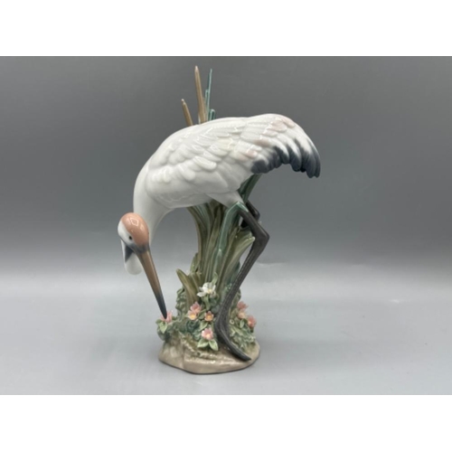 105 - Lladro figure 1613 Bowing Crane, one leaf missing, height 19cm, with original box