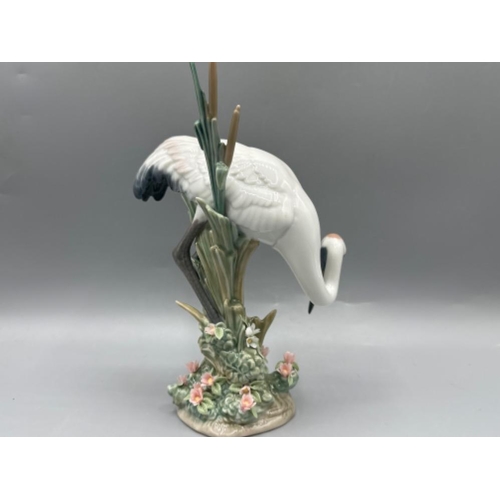 105 - Lladro figure 1613 Bowing Crane, one leaf missing, height 19cm, with original box