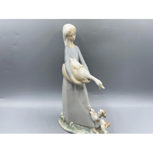 199 - Lladro 4866 ‘Girl with goose and dog’ in good condition - height 27cm