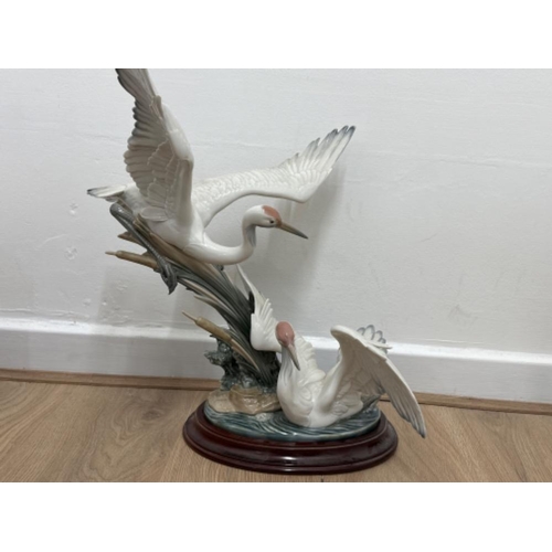 215 - Large Lladro “Cranes” figure 1456 Salvador Debon, with wooden base, good condition, H51cm X W43cm