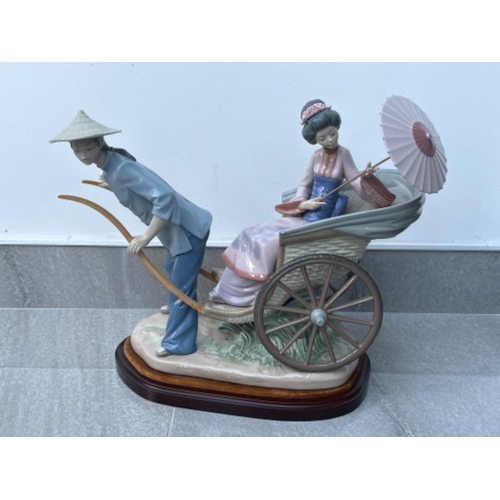 44 - Lladro 1383 ‘A Rickshaw ride’ in good condition with plinth and original box