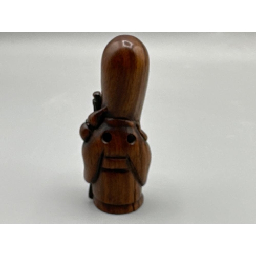 195 - Hand carved Japanese Netsuke in the form of a village elder, signed on base, H6cm