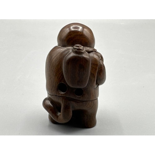 198 - An unusual Japanese hand carved Fertility Netsuke in the form of an animal/villager, H3cm x W4cm