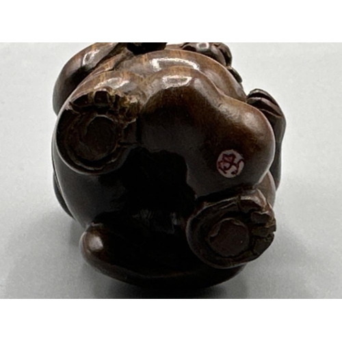 198 - An unusual Japanese hand carved Fertility Netsuke in the form of an animal/villager, H3cm x W4cm