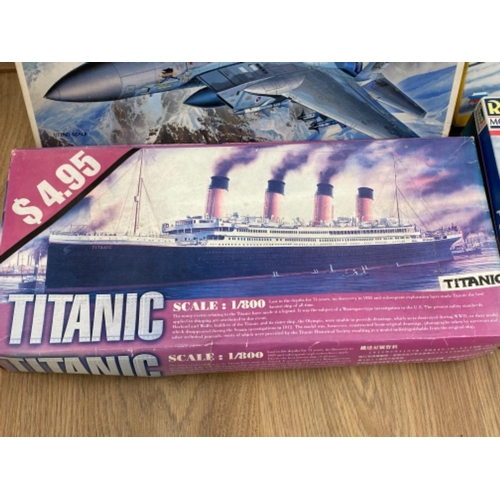 246 - 4x boxes of buildable vehicles to include The Titanic and F-15C Eagle