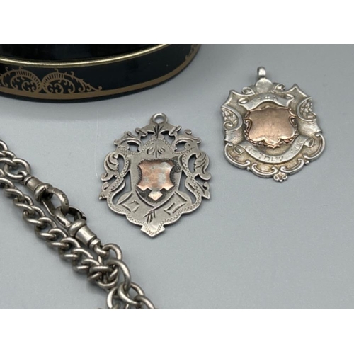 25 - Beautiful design tin containing hallmarked silver Albert chain, fobs and pocket watch (140g)