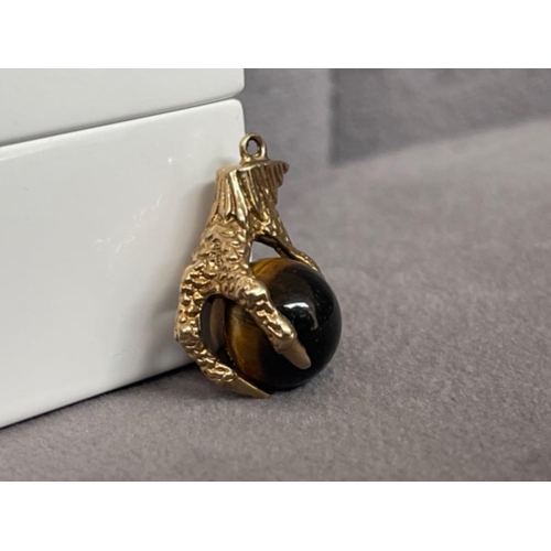 50 - A unusual Eagle Claw Charm hold a tigers eye stone - weighing 5.06 grams