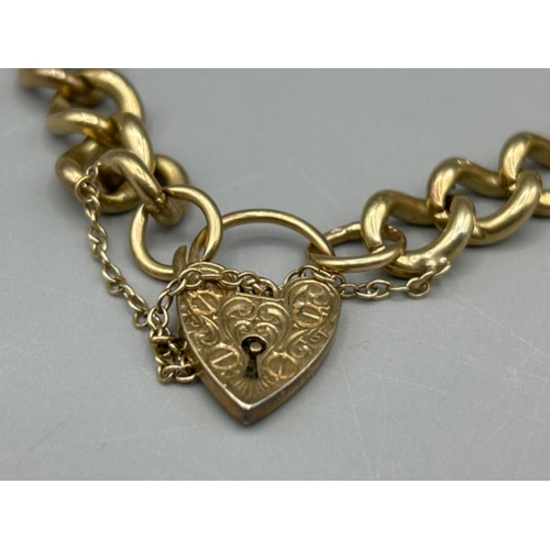 9 - Heavy 9ct gold curb chain bracelet with heart padlock, 23cms 26.89g