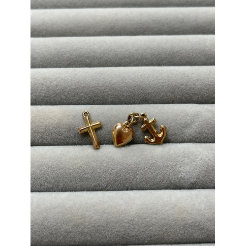 17 - Collection of three 9ct hallmarked charms including a cross, heart & anchor. This collection has a c... 