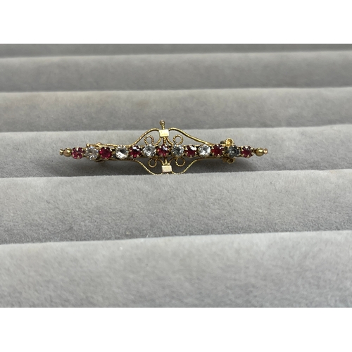 39 - 9ct Yellow Gold Fancy Design Brooch Featuring White and Red Stones Weighing 2.43 grams