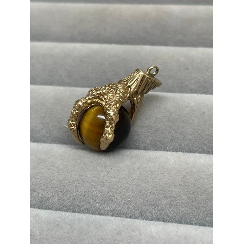 43 - 9ct Yellow Gold Eagle Claw & Tigers Eye Charm Weighing 5.55 grams