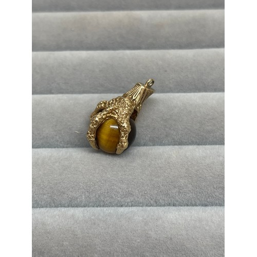 43 - 9ct Yellow Gold Eagle Claw & Tigers Eye Charm Weighing 5.55 grams