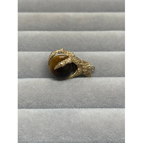 43 - 9ct Yellow Gold Eagle Claw & Tigers Eye Charm Weighing 5.55 grams