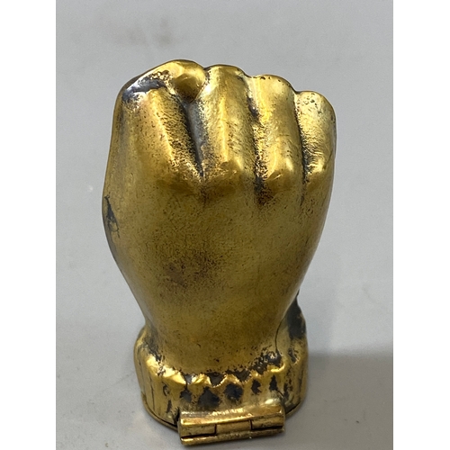 186 - A brass vesta case in the form of a fist