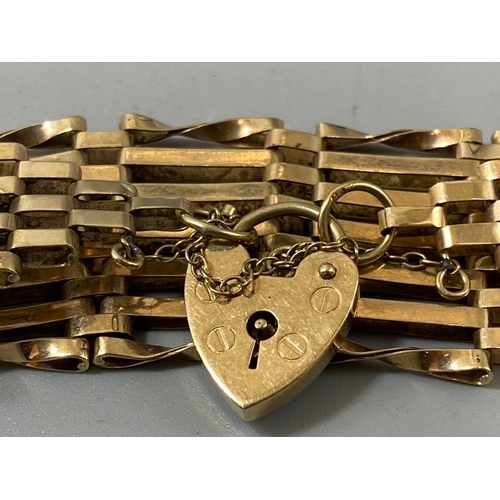 69 - 9ct yellow gold bar gate bracelet with love heart padlock, weight 15.44 grams 20cm in length