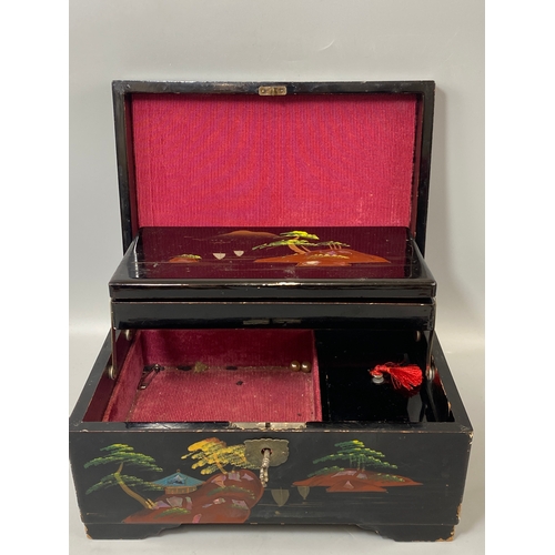 144 - Japanese black lacquer jewellery box which includes musical chimes