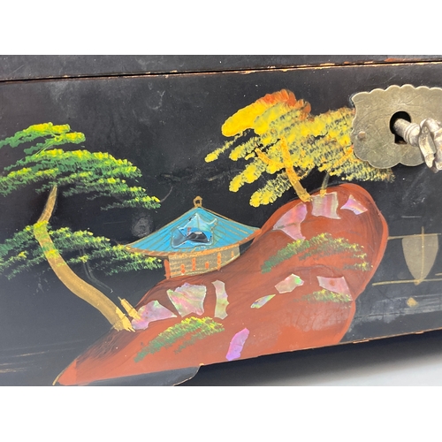 144 - Japanese black lacquer jewellery box which includes musical chimes