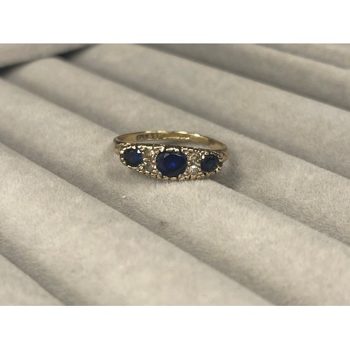 55 - 9ct Gold fully hallmarked Three Stone Sapphire Ring weighing 2.2 grams Size M