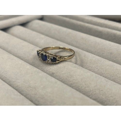 55 - 9ct Gold fully hallmarked Three Stone Sapphire Ring weighing 2.2 grams Size M