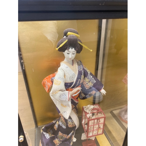 210 - 3x Japanese dolls in cases to include 2 large ladies and a small warrior