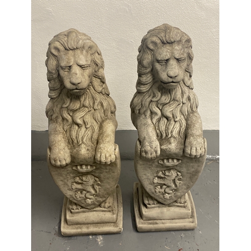 216 - 2x outdoor lion shield style garden statues height 82cm