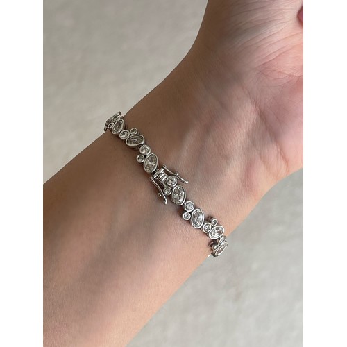 24 - Three Silver CZ Set Tennis Bracelets all of different designs weighing 30 grams collectively 

The t... 