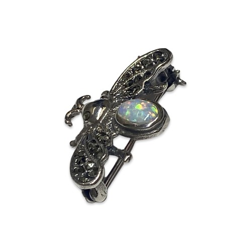 56 - Silver, Opal and marcasite bug brooch weighing 4.55 grams

Measuring 3.5cm in length x 2cm in height