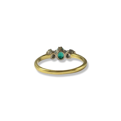 94 - 18ct London 1982 yellow and white gold Emerald and diamond trilogy ring featuring an oval emerald we... 