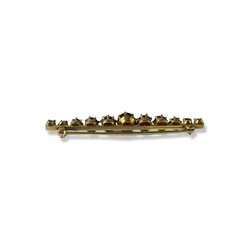 72 - 9ct yellow gold garnet bar brooch comprising of 11 round cut garnet weighing approximately 2cts this... 