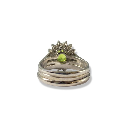 83 - A stunning 14ct White Gold three band design peridot and diamond cluster ring comprising of an oval ... 