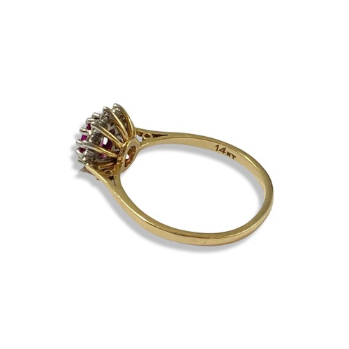 86 - 14ct Yellow gold Ruby and Diamond cluster ring featuring an oval ruby stone weighing approximately 0... 