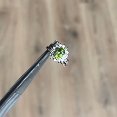 83 - A stunning 14ct White Gold three band design peridot and diamond cluster ring comprising of an oval ... 